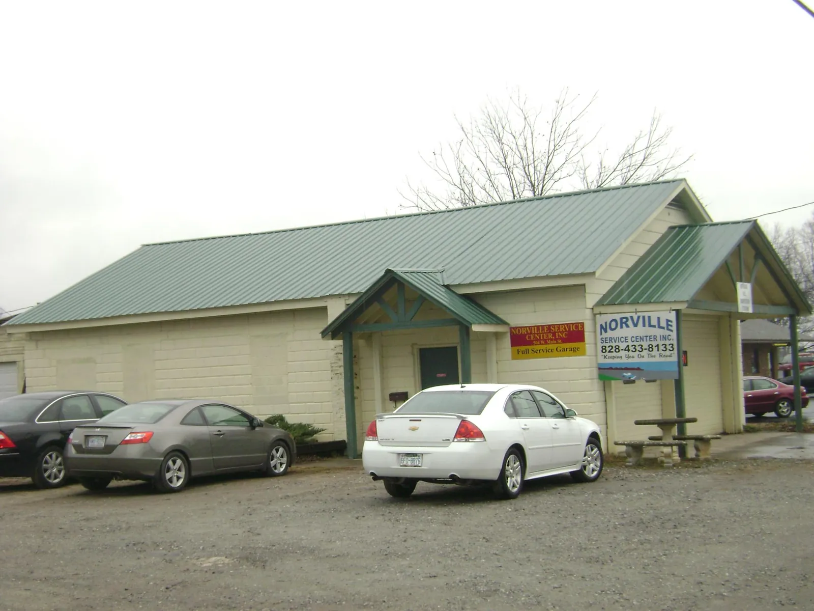 Green metal roof on a service garage with a covered entry in Fruitland Park
